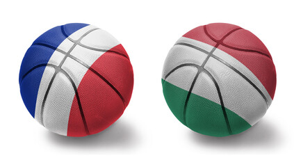 basketball balls with the national flags of hungary and france on the white background.