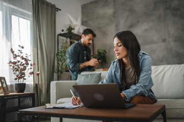 Fototapeta premium Adult young caucasian woman work from home and use laptop