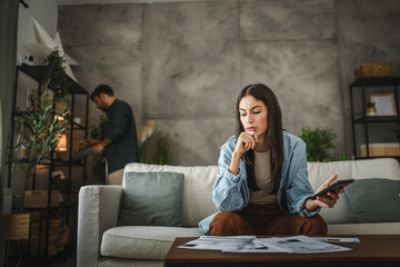 Worried adult woman think and calculate how to pay domestic finances
