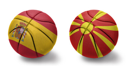 basketball balls with the national flags of macedonia and spain on the white background.