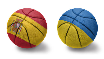 basketball balls with the national flags of ukraine and spain on the white background.