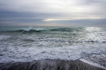 Waves of Bordighera sea at sunset. Bordighera is located 20 kilometres (12 mi) from the land border between Italy and France.