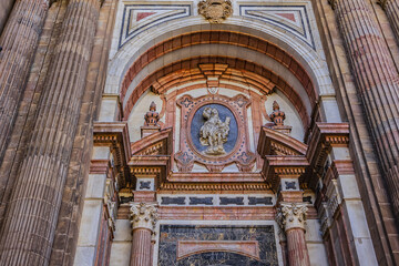 Fototapeta premium Architectural details of entrance to Malaga Cathedra. Cathedral is Roman Catholic Church (Santa Iglesia Catedral Basilica de la Encarnacion), was constructed in 1528 -1782. Malaga, Andalusia, Spain.