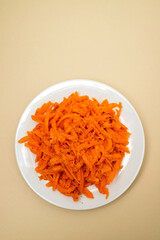 salad with fresh carrot on the white plate