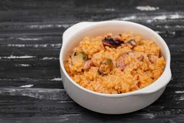 traditional portuguese dish rice with seafood in white dish