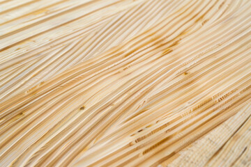 Detailed shot of light-colored wooden surface highlighting fine grain and texture under bright lighting.