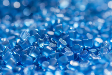 Close-up of shiny blue plastic pellets, highlighting their glossy texture and vibrant color.