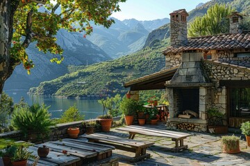 Obraz premium Rustic stone cottage with lush garden and mountain view.