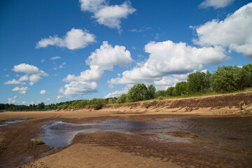 Beautiful summer landscape with clouds on the river.