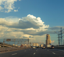 A busy highway with a large building in the background