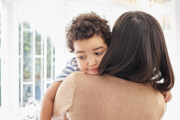 Boy, mother and embrace child in home for bonding, comfort and development with love, care and...