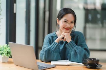 Asian female student working with laptop computer