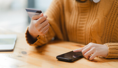 Happy Asian businesswoman shopping online using mobile phone