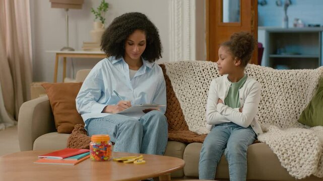 African American psychologist home reception patient mental psychology health woman little girl child talk conversation dialogue professional specialist write complaints trust consultation communicate