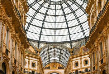 Obraz premium Low-angle view of the iron and glass dome of the Galleria Vittorio Emanuele II historic shopping gallery, Milan, Lombardy, Italy