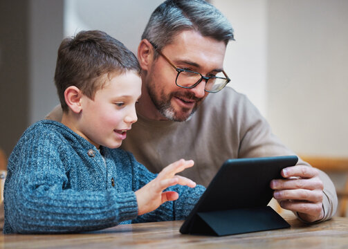 Tablet, learning and dad with child in home for online classes, school project and lesson. Family, education and father teaching boy on digital tech for help with studying, homework and assignment