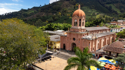 Fototapeta premium Pueblorrico, Antioquia - Colombia - July 21, 2024. Facade of the Catholic church located in the main park of the municipality.