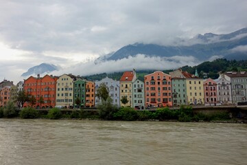 Obraz premium Clouds drift over Innsbruck, a city nestled in the Austrian Alps