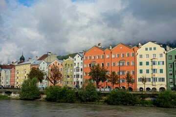 Obraz premium Clouds drift over Innsbruck, a city nestled in the Austrian Alps