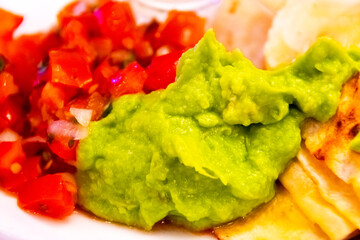 Dish served with a portion of guacamole and pico de gallo, Latin American food in a hotel interior.