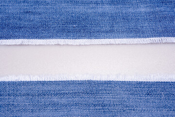 Jean denim pattern for textured background. Denim jeans texture. Ripped denim or blue jeans. Blank space for advertising.