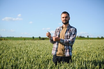 Portrait of farmer standing in wheat field