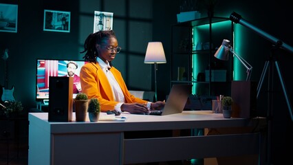 African american pupil takes notes from digital libraries and academic databases, distant education concept. Conducting virtual interviews or surveys for research on bachelor paper. Camera B.