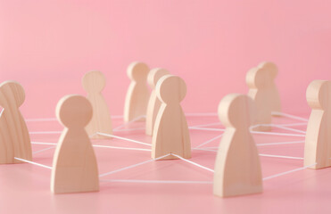Wooden figures connected by lines, representing the concept of network and social interaction. People connecting in an office or business setting.