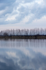 Fototapeta premium a beautiful reflection of the sky and clouds in the lake at sunset
