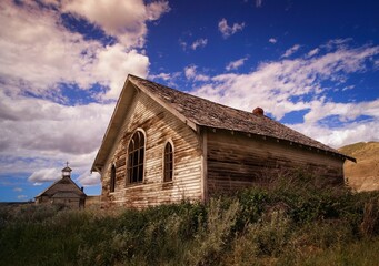 Weathered Wooden Building And Church