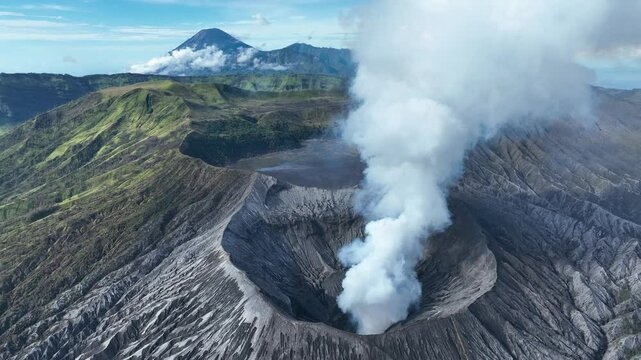 Aerial video of smoking mount Bromo volcano crater on East-Java, Indonesia