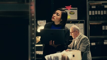 Private investigator organizes archived files for easy access, searching for old file cases to...