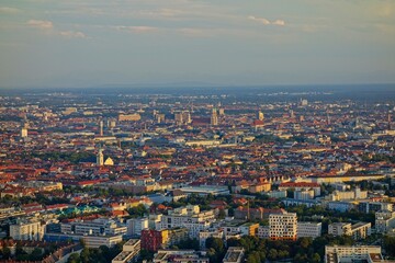 Fototapeta premium The Olympiaturm tower in Munich, Germany overlooks the city and the Bavarian Alps in the distance