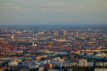 The Olympiaturm tower in Munich, Germany overlooks the city and the Bavarian Alps in the distance