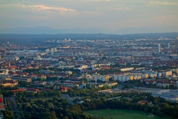 The Olympiaturm tower in Munich, Germany overlooks the city and the Bavarian Alps in the distance
