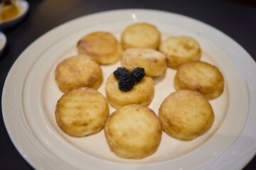 Fried potato rounds with caviar on a white plate can elevate your appetizer selection