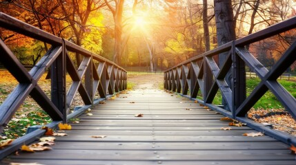 Obraz premium A wooden bridge with a view of trees and leaves on the ground