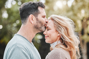 Mature couple, forehead kiss and nature for support, love and affection for spouse on holiday. Happy people, profile and vacation for bonding on travel, trust and countryside security in commitment