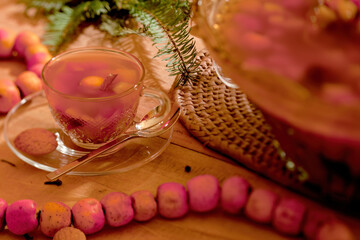 Cup of fruit punch with punch bowl next to it.
