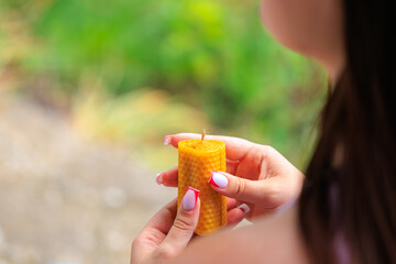 A woman holding a candle in her hand
