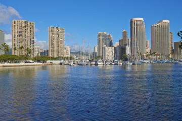 Obraz premium City, sea and sky with business architecture outdoor in Hawaii, USA for commercial or corporate trade. Background, infrastructure and nature with buildings in urban town for work in sunny environment