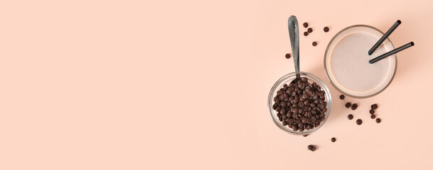 Glass of sweet chocolate milk on beige background with space for text