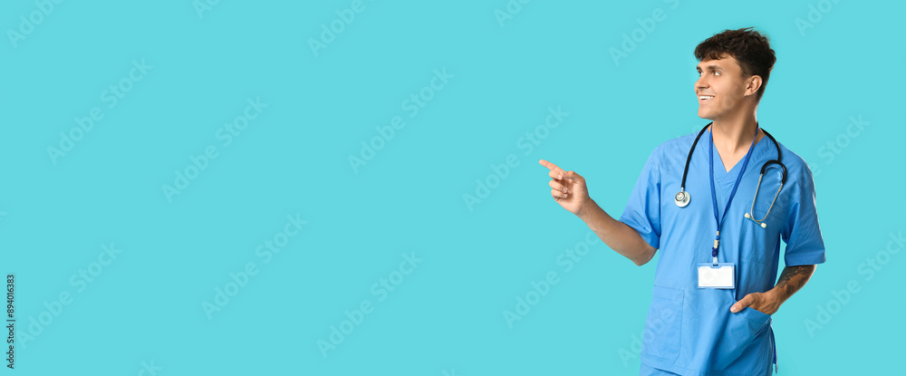 Poster male medical student with stethoscope and badge pointing at something on blue background