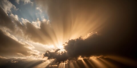 Fototapeta premium A dark cloud obscures the setting sun, but golden beams of light pierce through the clouds