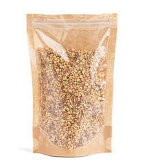Pack with raw buckwheat grains on white background