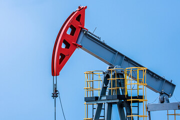 Oil drilling derrick pumps oil from ground. Petroleum industry, crude oil extraction.