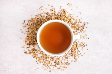 Cup of tasty fresh buckwheat tea on light background