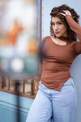 Young woman touching hair while posing outdoors