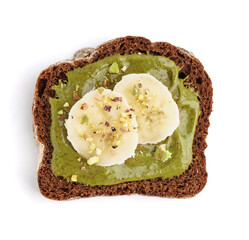Piece of bread with tasty pistachio paste and banana slices on white background