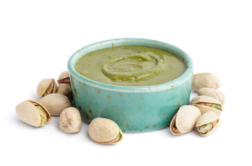 Bowl with tasty pistachio paste on white background